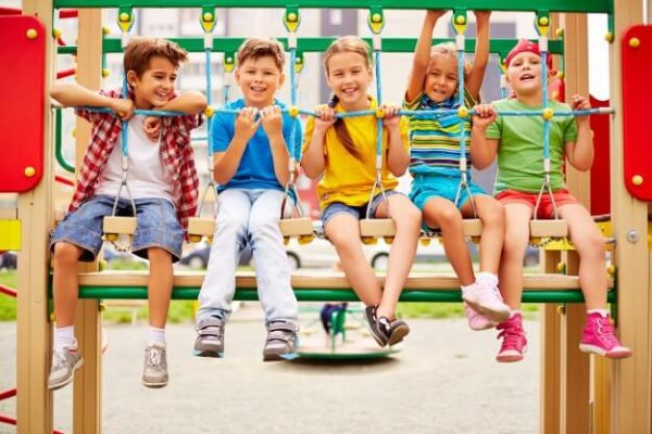 smiling-classmates-sitting-in-a-row-on-the-playground_1098-3964 3